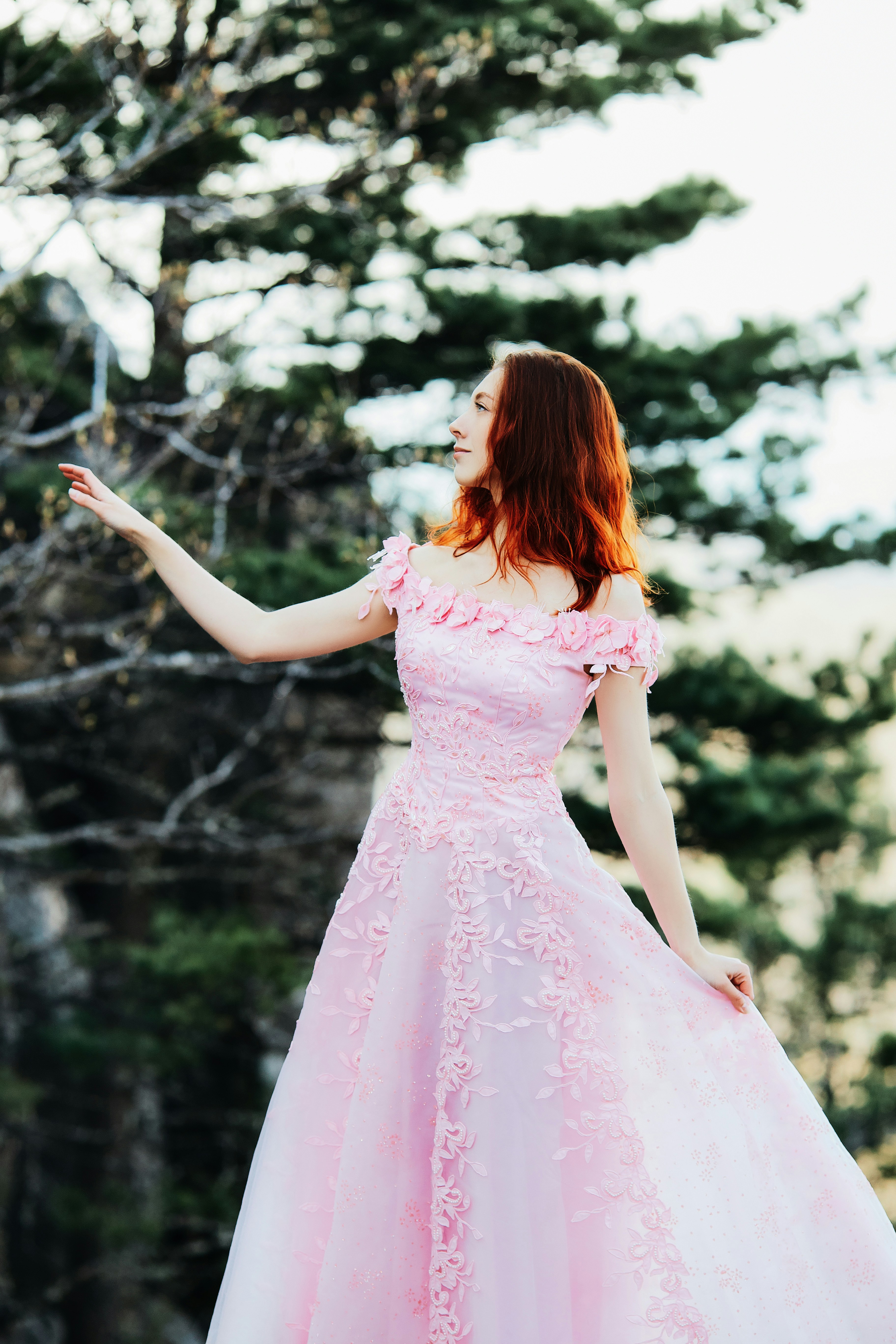 girl in pink dress standing on forest ...